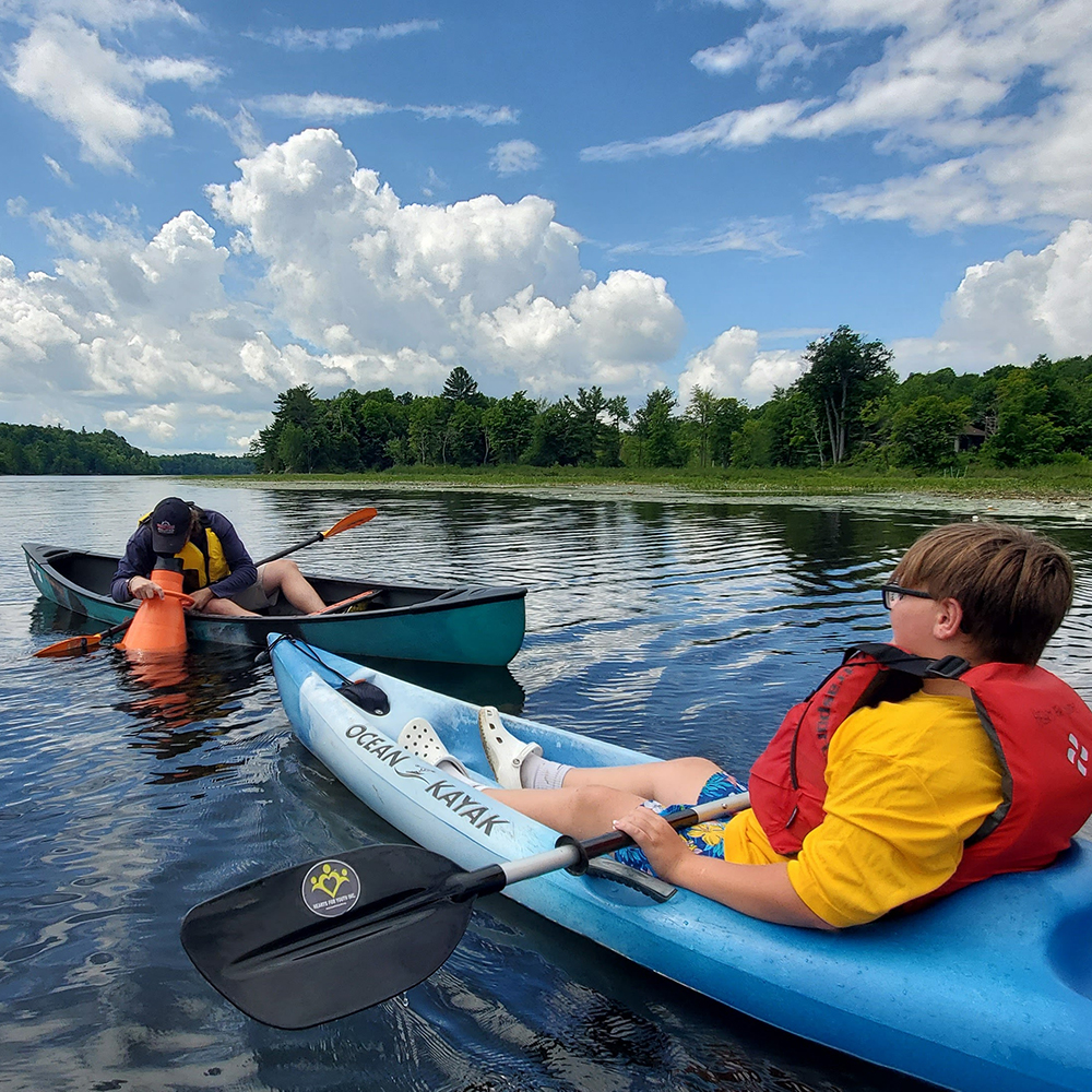 Two youth kayaking the lake