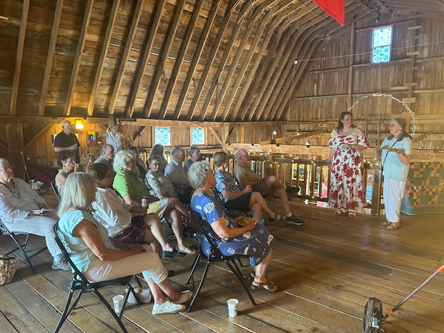 Individuals sitting while listening to a speaker