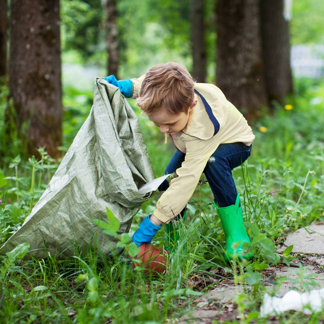 Child picking up trash on a trail