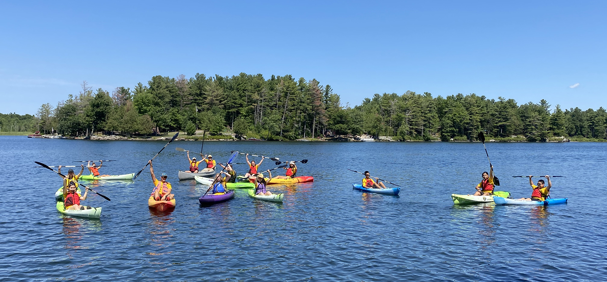 Teens in kayaks float on Clear Lake