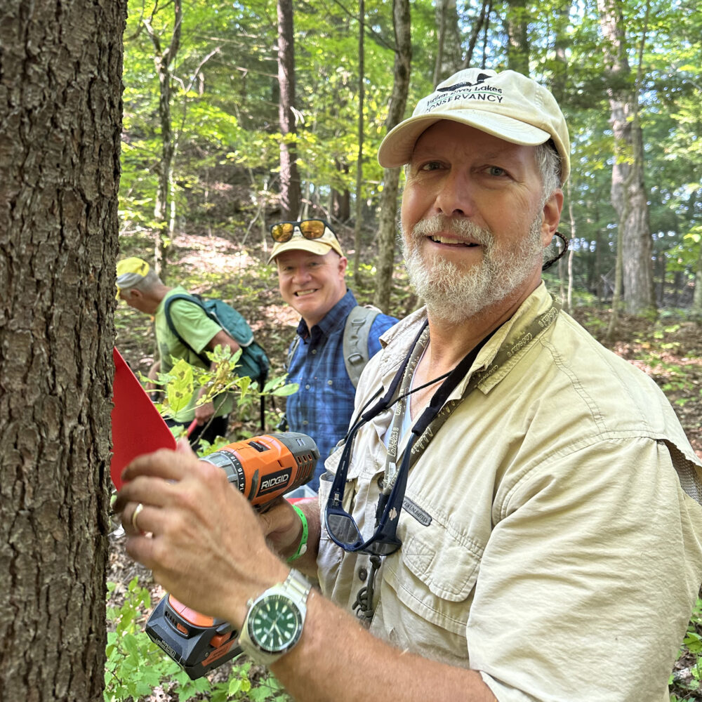 Steve Swallow hanging a trail marker