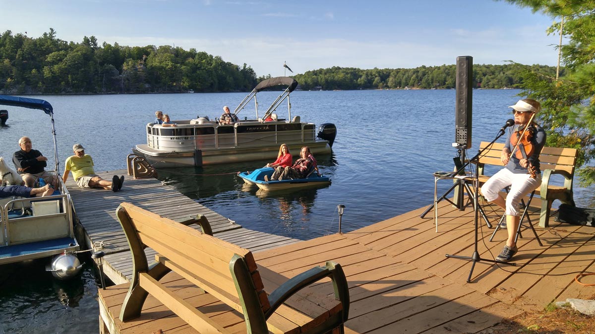 musicians playing to lake residents