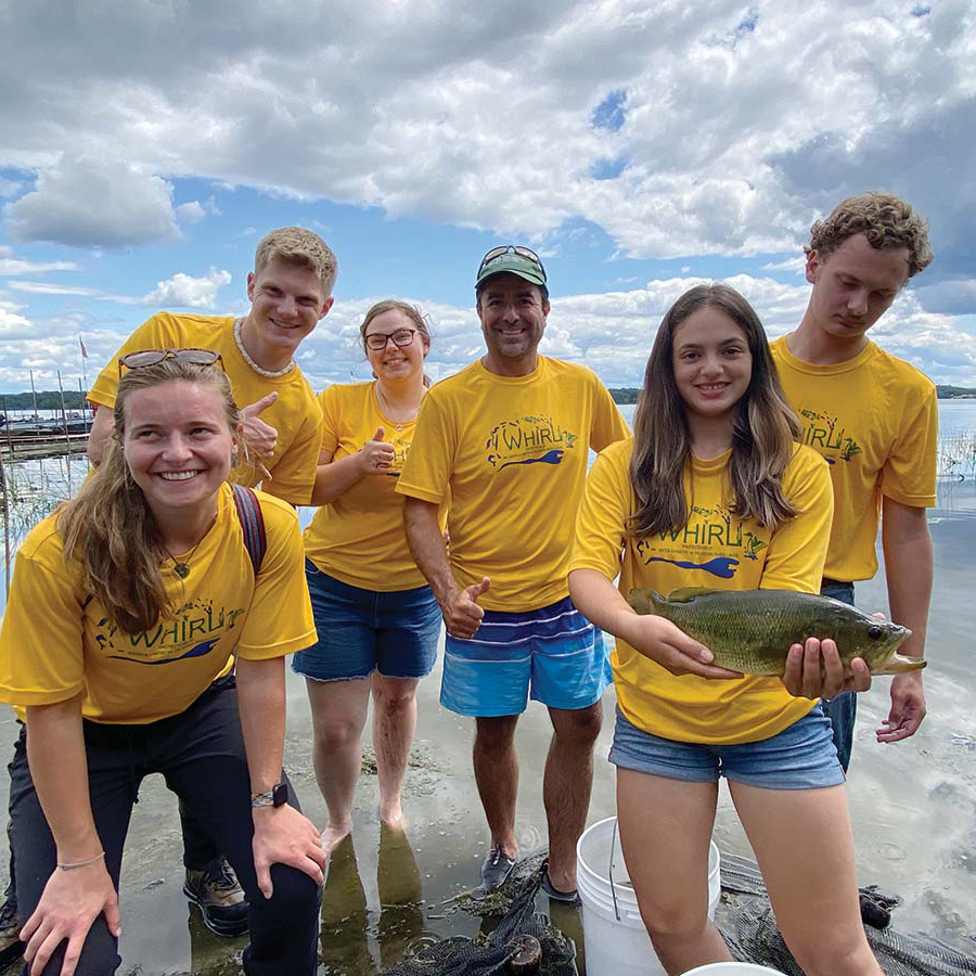 Group of students in a Lake with a fish