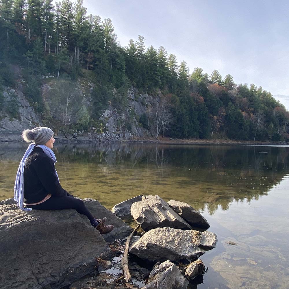 Red Lake Shoreline photo with person sitting on a rock