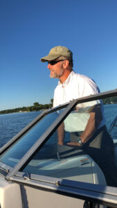 photo of Stephen Swallow driving a boat