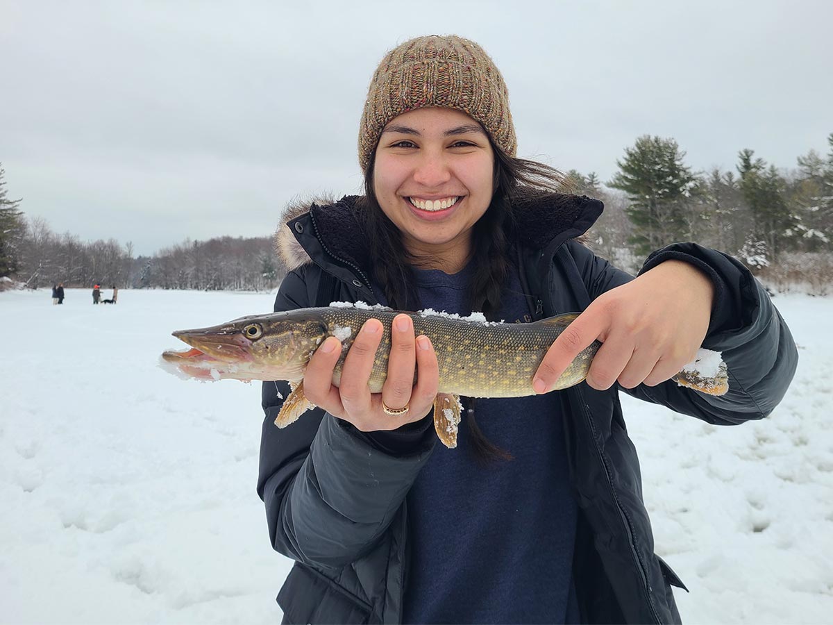 youth holding the pike fish they caught
