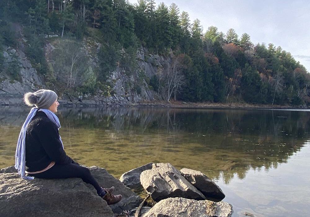 Red Lake Shoreline photo with person sitting on a rock