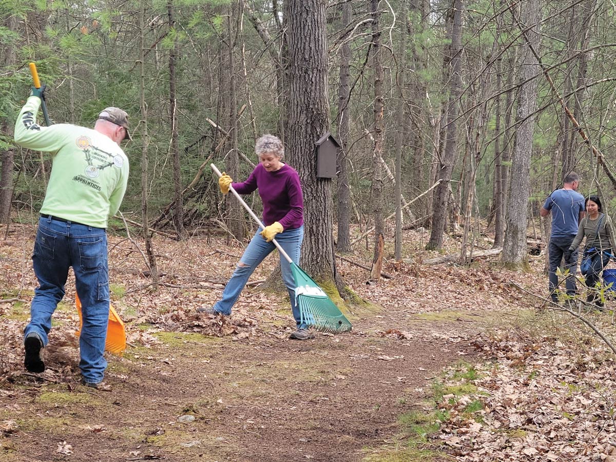 four volunteers working on trails